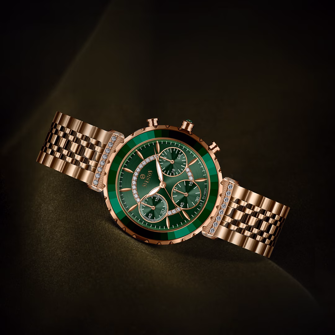 Rose-gold Sveston chronograph with an emerald green dial in a dark studio composition